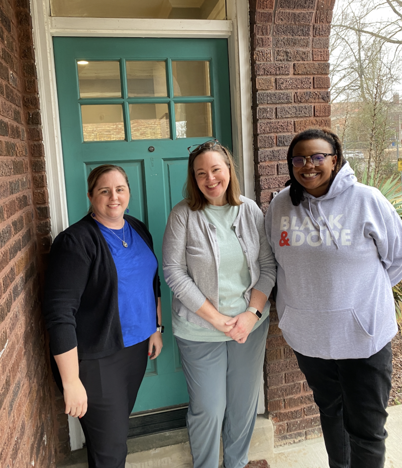 three women pose for photo