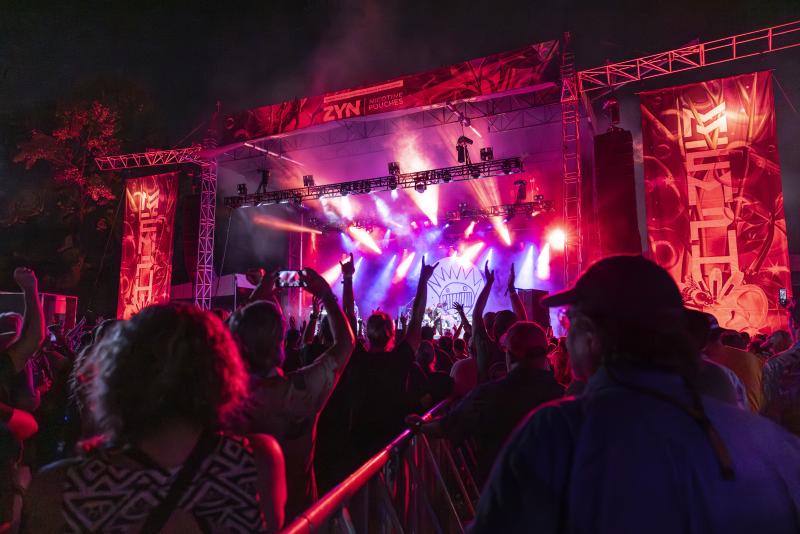 viewpoint from fan at mempho music festival looking around stage lit up in pink and red