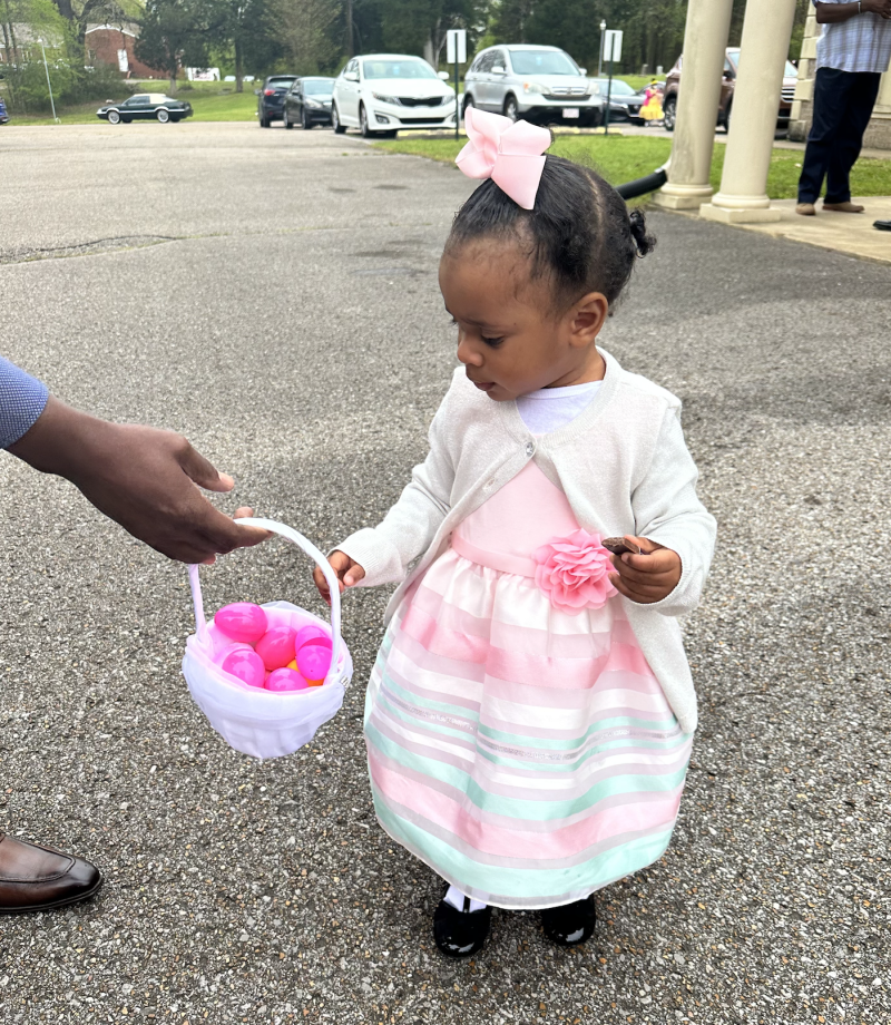 toddler in dress with Egg basket