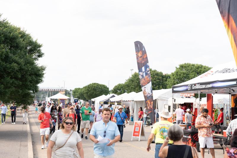 people walking past tents at WCBCC