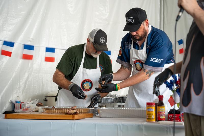 two men prepping barbecue at WCBCC