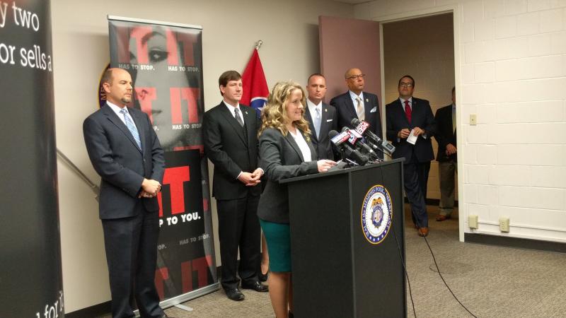 woman stands at podium during press conference