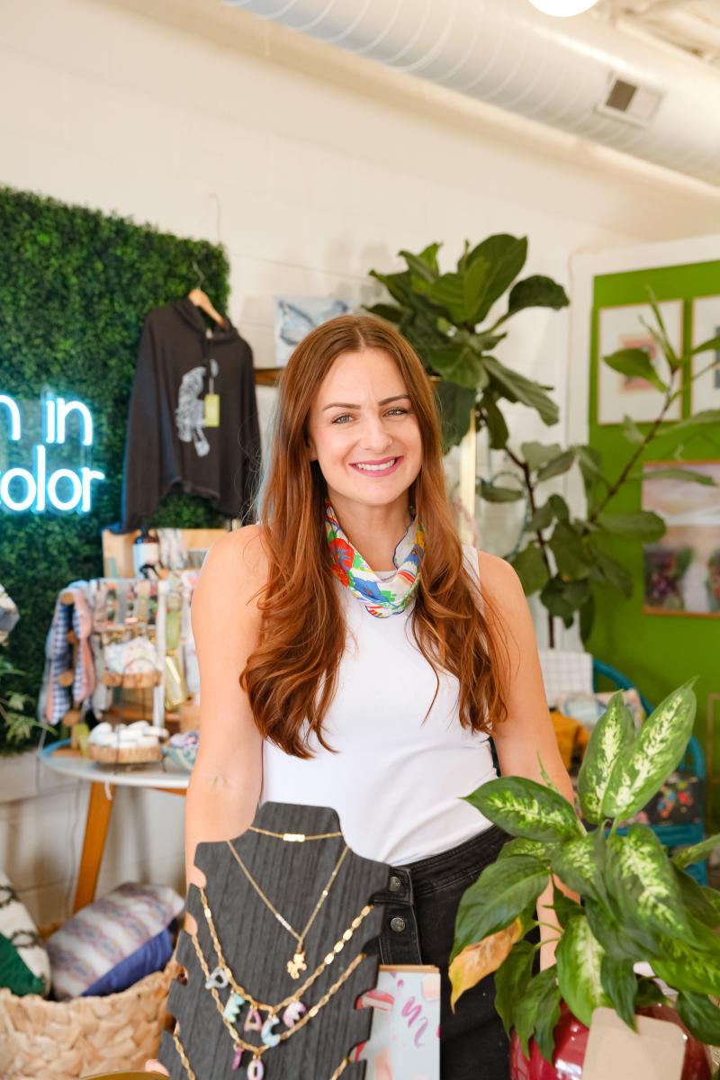 Whitney Winkler smiles for photo in her studio and shop