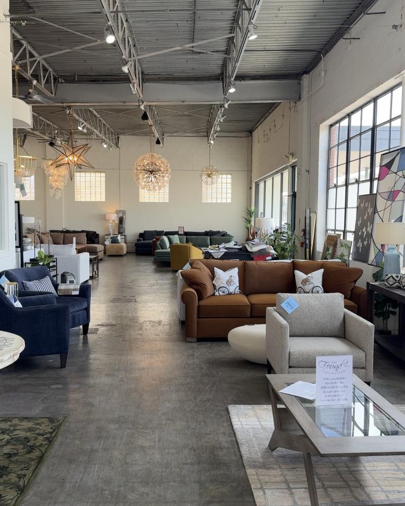 showroom for The Find filled with different colored couches, fancy chandeliers, and artwork
