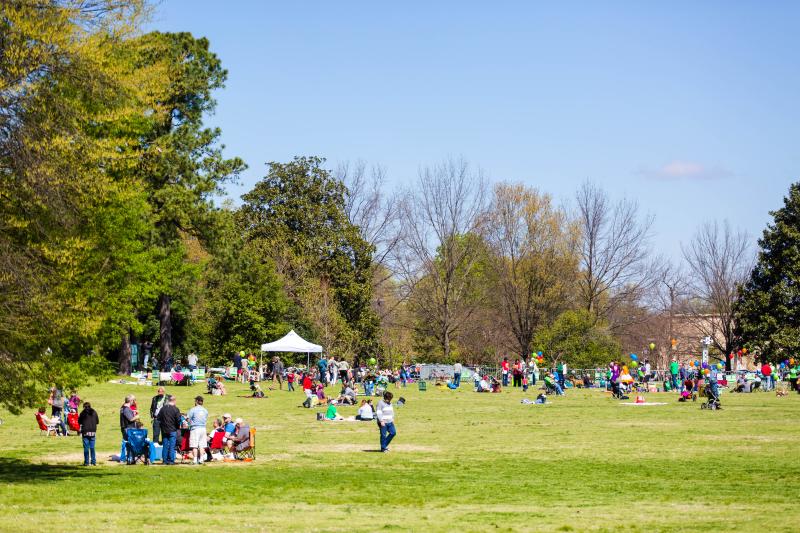 open field at Overton Park spread out with people sitting in chairs and blankets