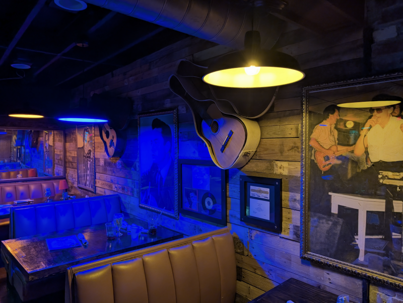 booth tables lining wall with memorabilia on it