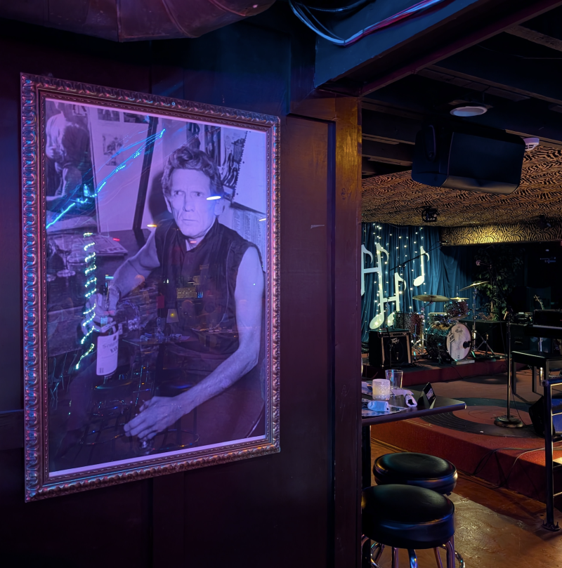 photo of jerry lee on wall with stage in background