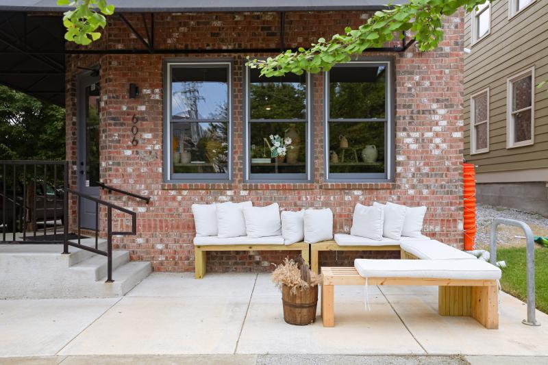 exterior entrance to brick store with lounge seating