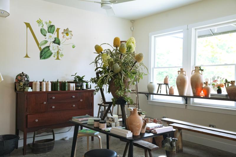 shop floor with pottery, plants, and beauty products on display