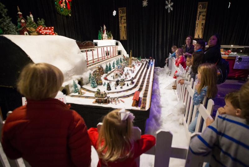 Children catch a glimpse of the Christmas displays at the Enchanted Forrest and the Pink Palace Museum.