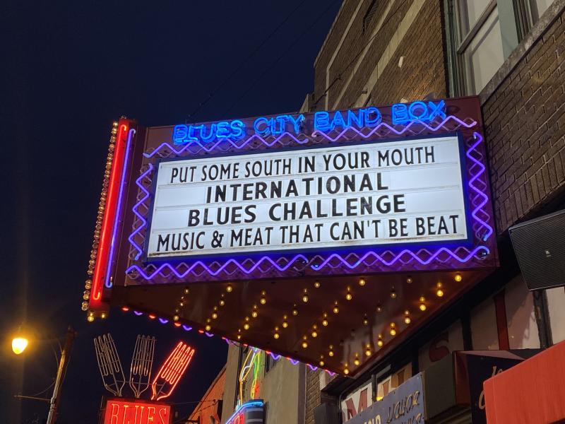 neon sign with Internation Blues Challenge on it