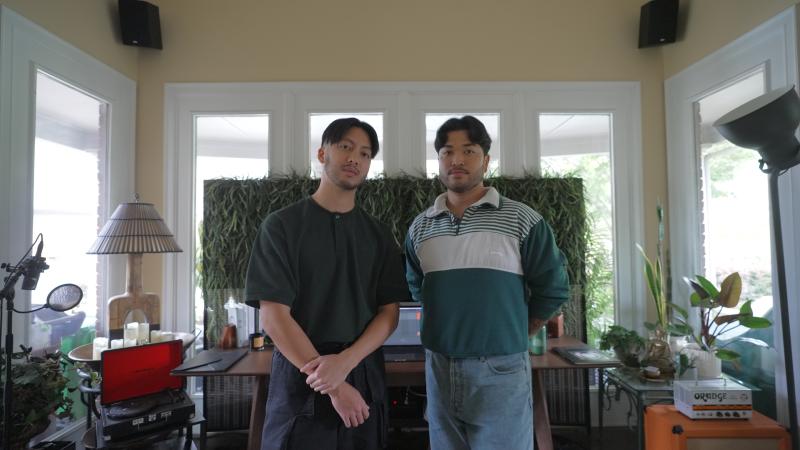 photo of two filipino men standing side by side looking into the camera with straight faces