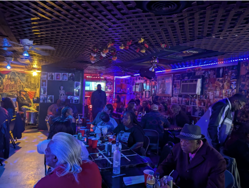 a room full of people sitting and listening to music