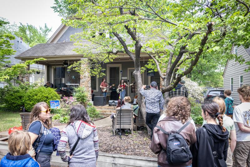 people gather on lawn to watch band perform during Porchfest