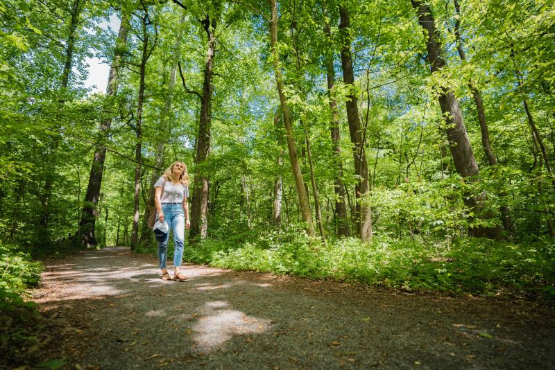 Picture of woman walking through the trails in the Overton park forest