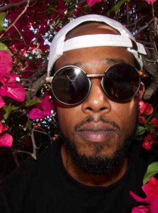 man in sunglasses and a white backwards baseball cap