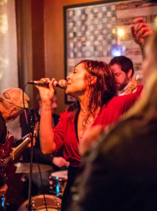 woman singing in intimate concert venue