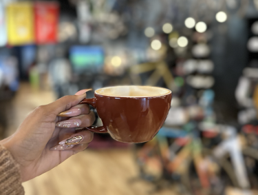 coffee held up in store with background blurred