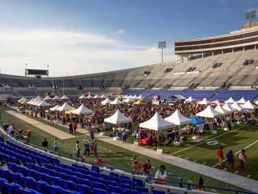dozen plus pop up tents set up on field inside Simmons Bank Stadium for chicken and beer festival