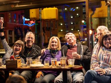 group of friends sitting and have drinks and smiling