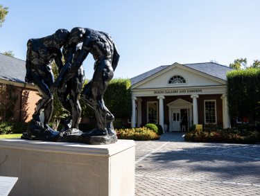 dixon exterior entrance with statue of three people hunched over 