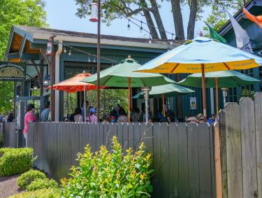 patio and umbrellas with people dining at Celtic crossing Irish pub