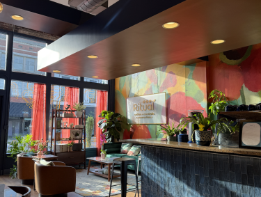 ritual coffee dining space and sidebar with colorfully painted wall 