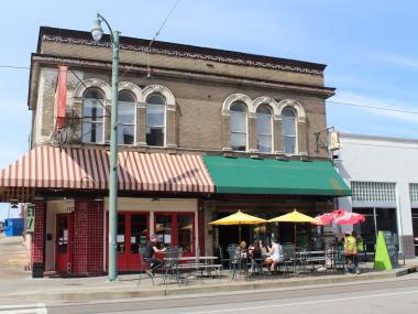 Historic Green Beetle bar building with red and green awning
