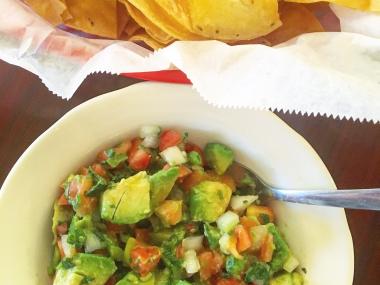 bowl of guacamole and chips