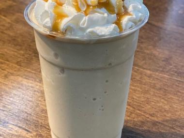 frozen coffee drink with whipped cream and caramel drizzle