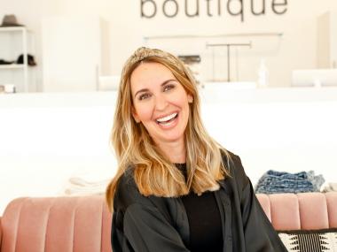 portrait of women on a couch in a boutique, Mozelle Sign on the wall