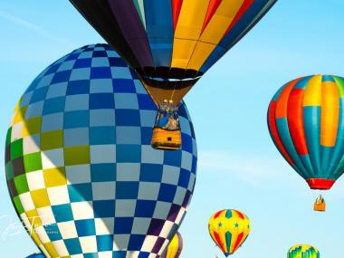 colorful hot air balloons floating through blue sky