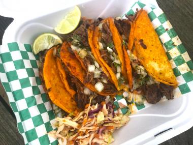 tacos in a to=go container with slaw