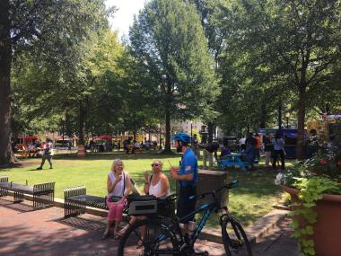 people at the park with food trucks