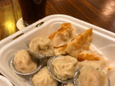 soup dumplings and potstickers with a dark beer