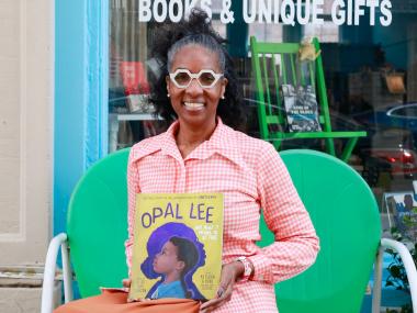 author holding children's book