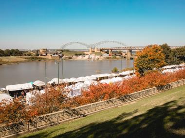 Riverside Dr. with tents for RiverArtsFest with the Hernando de Soto "M" bridge in the background.