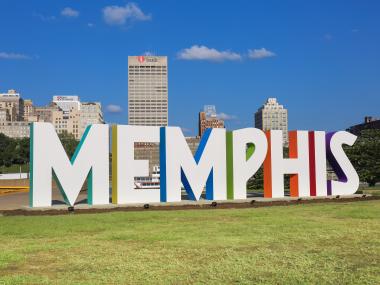 Photo of the "Memphis" letters on Mud Island with the city skyline in the background