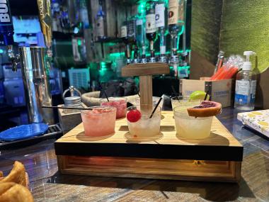 photo of margarita flight in container. six different drinks