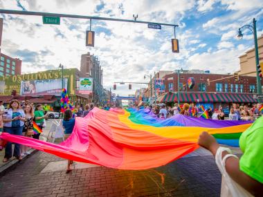 rainbow flag being walked down beale street during pride festival