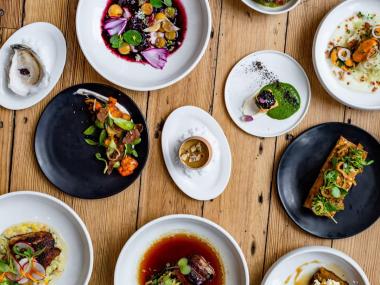 many plates of different sizes with different types of food