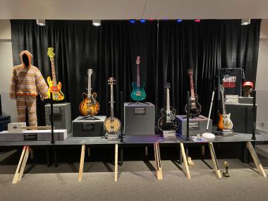 7 guitars on display, all different kinds but