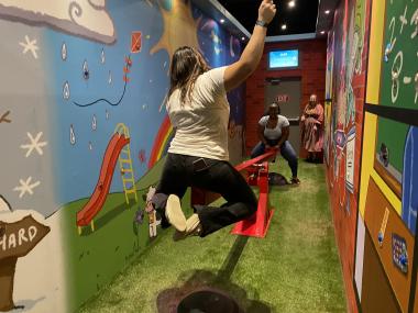 two girls on a see saw in themed room