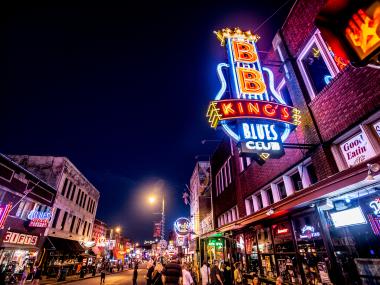 nighttime view of beale street with neon signs lit up
