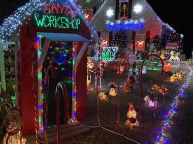 home decorated with christmas lights and Santa house