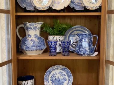 white and blue china on display