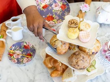 afternoon tea setup with tea pots and treats