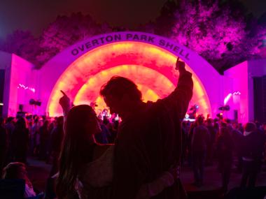 A couple stands together in front of Memphis' Overton Park Shell during a concert