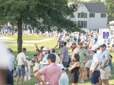 spectators line golf course at tournament