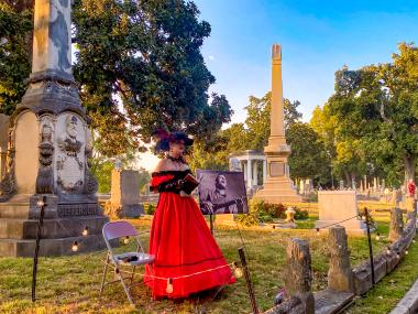 actress dressed in victorian clothes at Elmwood Cemetery